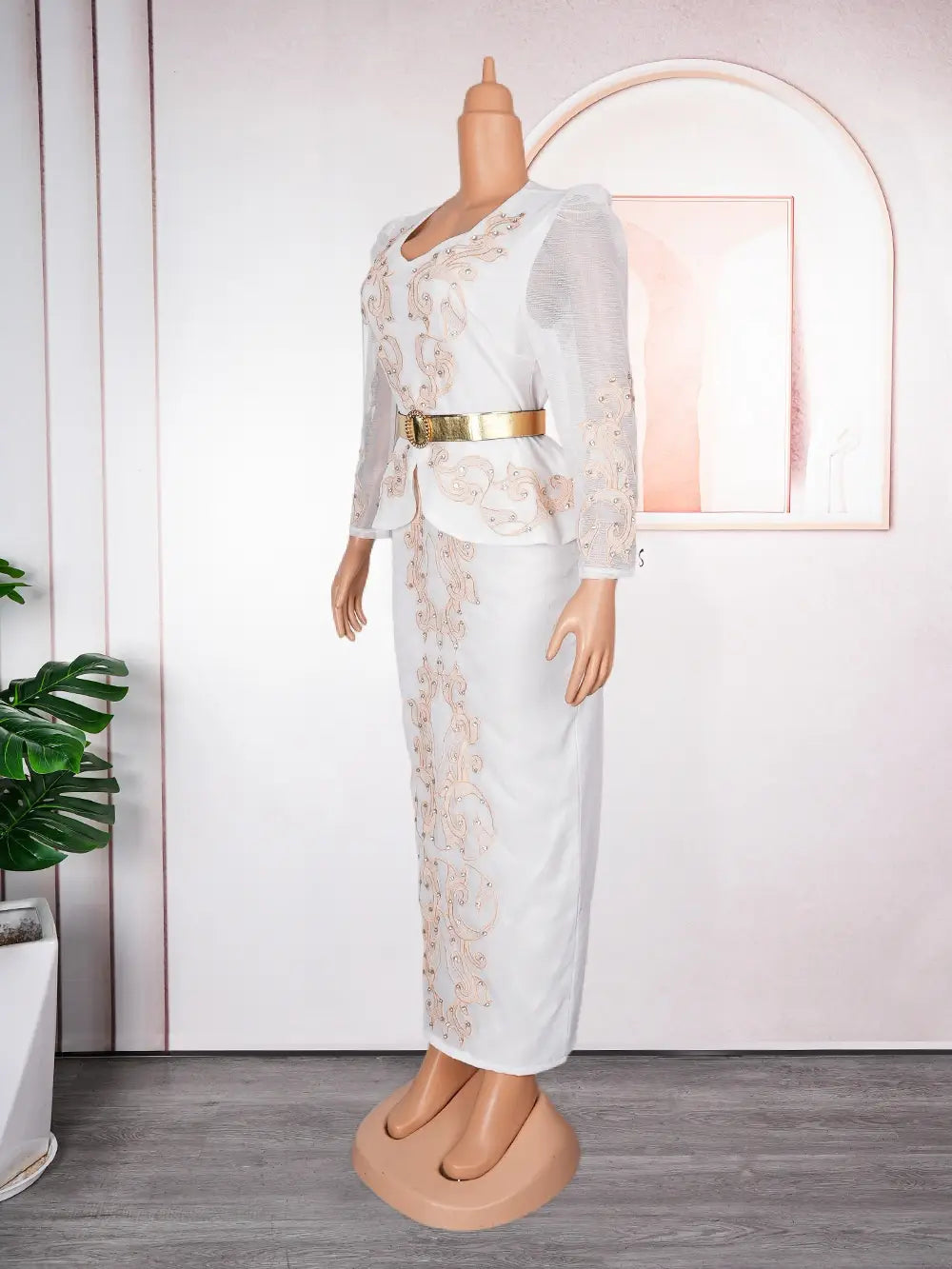 Luxury rhinestone beaded white lace dress with delicate gold embroidery and a matching peplum top accented by a metallic belt.