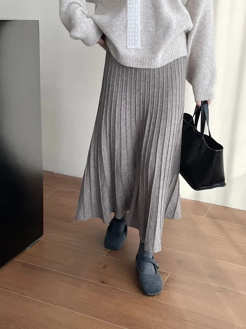 a soft gray ribbed knit midi skirt featuring a korean elastic waist and a flowing waist knitted pleated design
