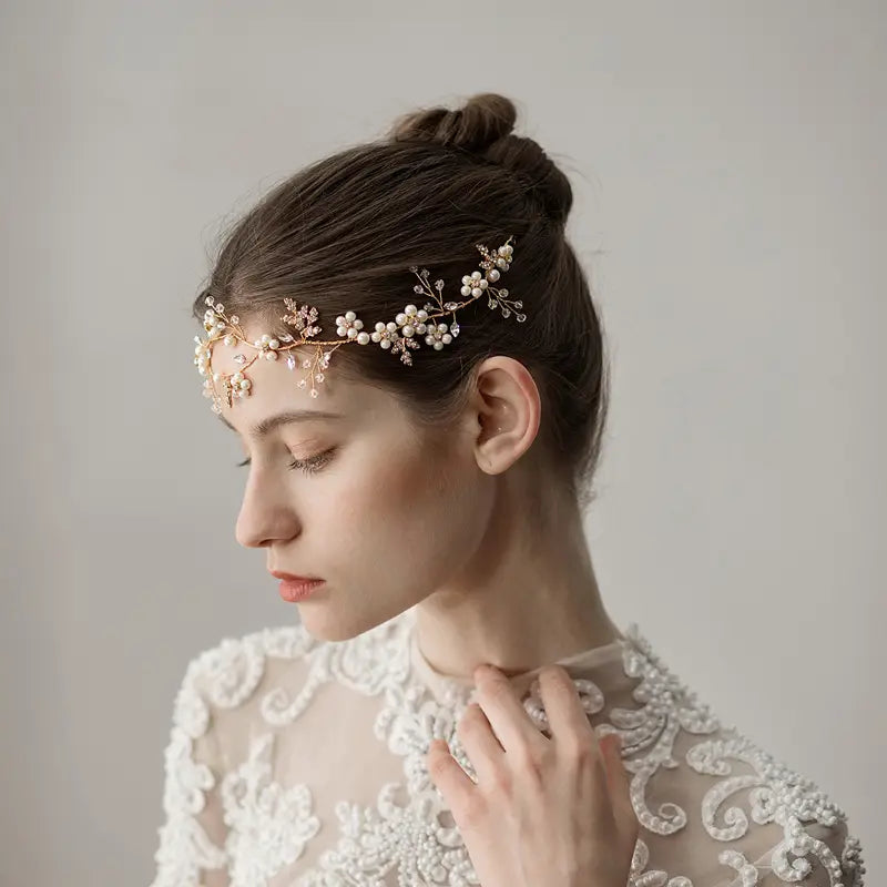 Delicate gold-toned pearl flower wedding headband adorned with tiny pearls and sparkling crystals designed as a floral vine for elegant wedding headband accessories.