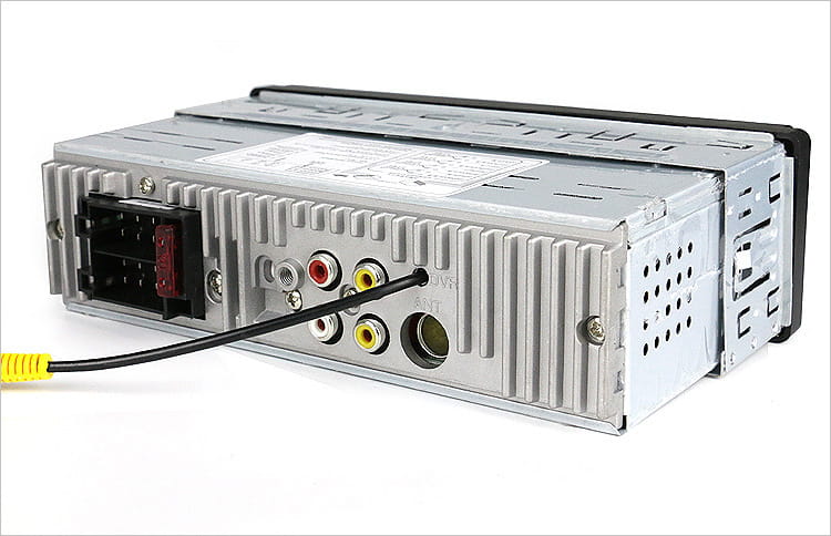 silver-colored car mp5 player with ribbed metal casing showing the back side with multiple audio input jacks and an attached yellow-capped cable for large screen bluetooth use