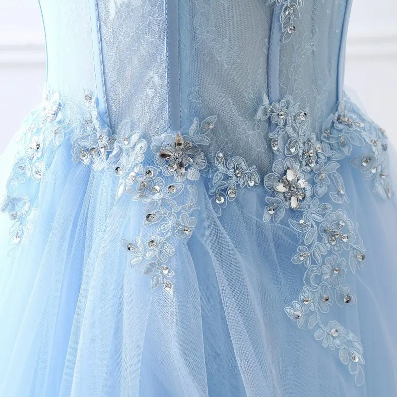 a light blue slim fit bridesmaid gown made of delicate tulle with intricate lace appliqués and sparkling crystal flowers along the waistline, ideal for an annual meeting or formal event.