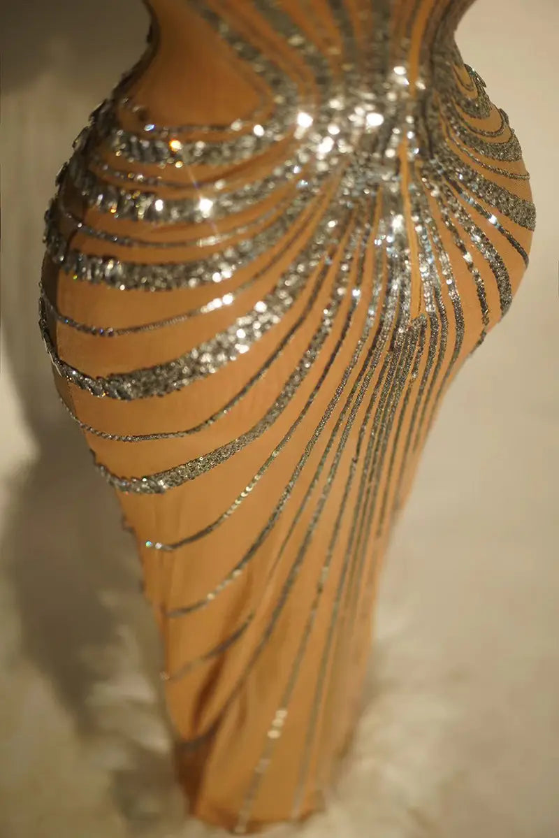 a shimmering tan rhinestone feather dress banquet gown adorned with intricate silver beaded stripes cascading down its form