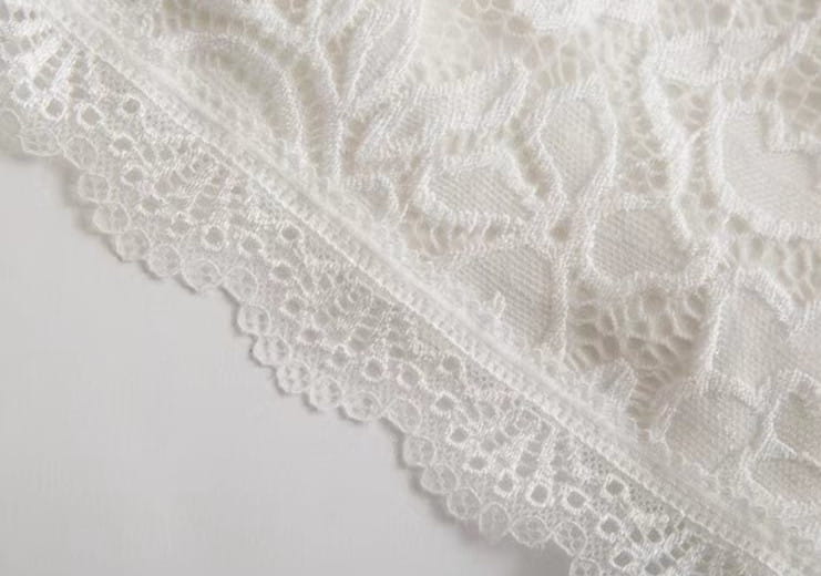 white floral lace trim with delicate intricate patterns and scalloped edge on women shorts lace scalloped hem elastic waistband