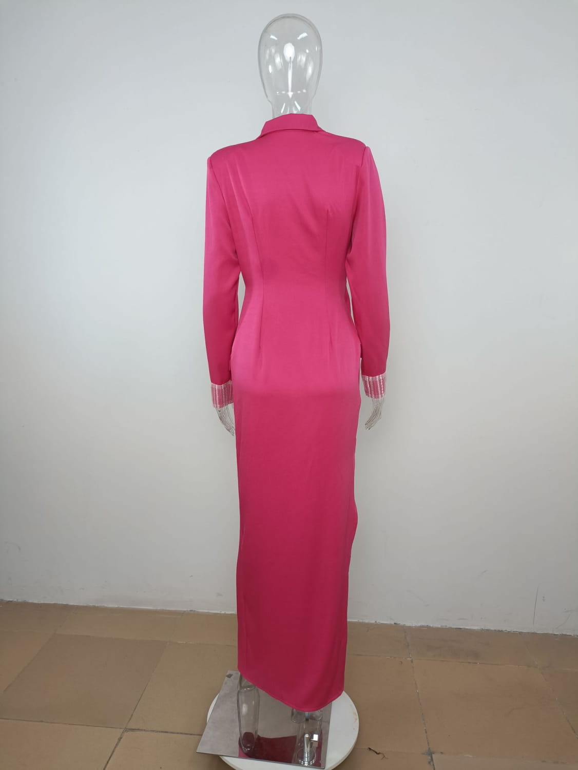 A vibrant rose red suit collar embellished wrap dress with a fitted long-sleeved design, collar, and striped cuffs displayed on a mannequin.