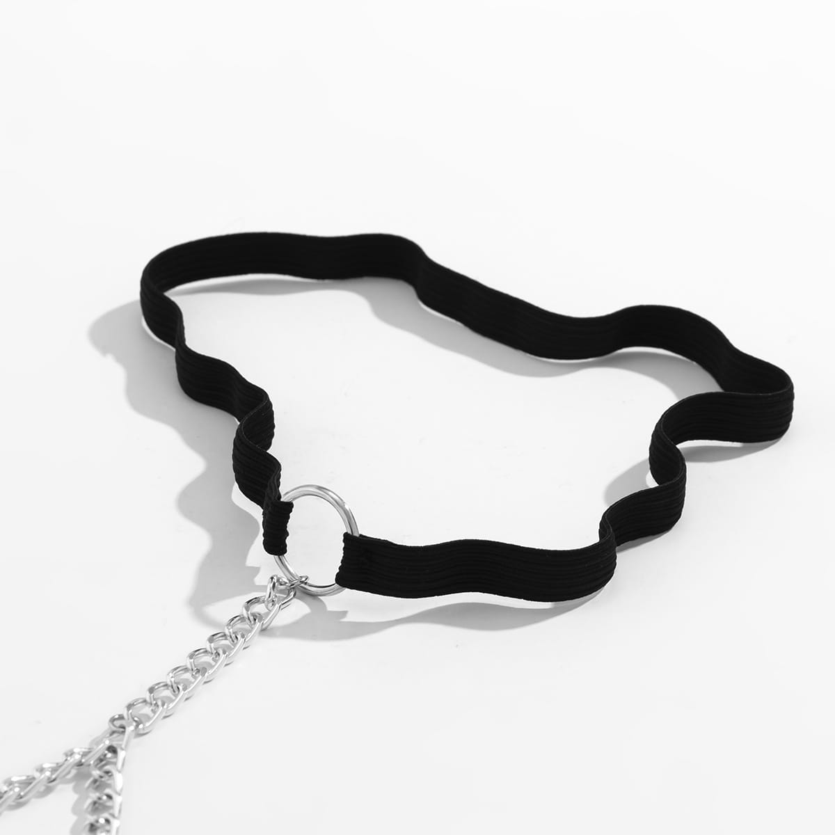 black elastic geometric body chain thigh garter featuring a black velvet choker with a silver chain and ring detail designed as simple geometric body jewelry simple geometric accessory.