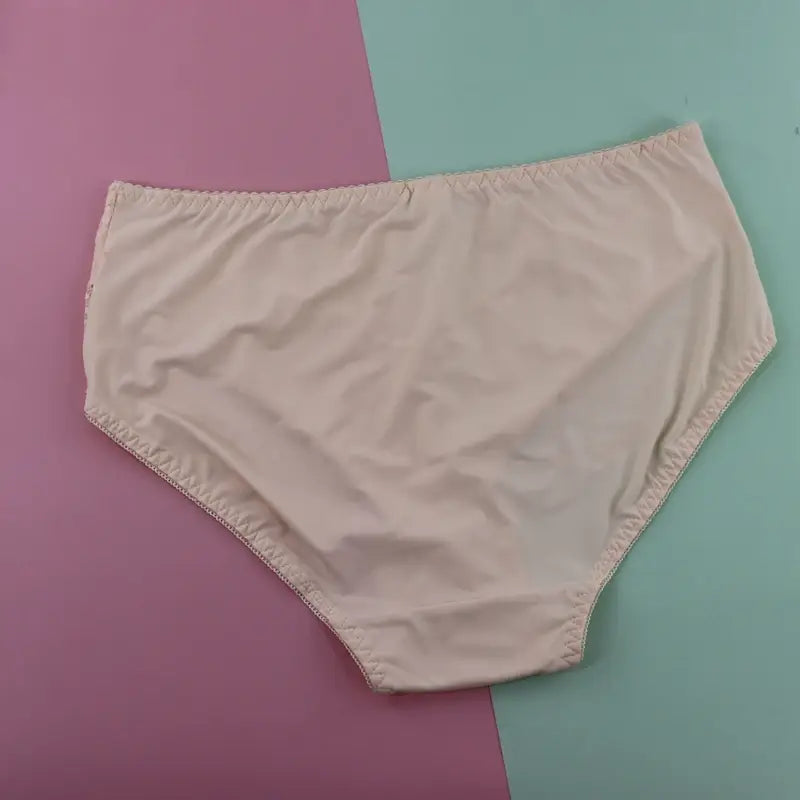 beige cotton briefs with elastic waistband and rolled hem complement a plus size underwire lace trim lingerie set.