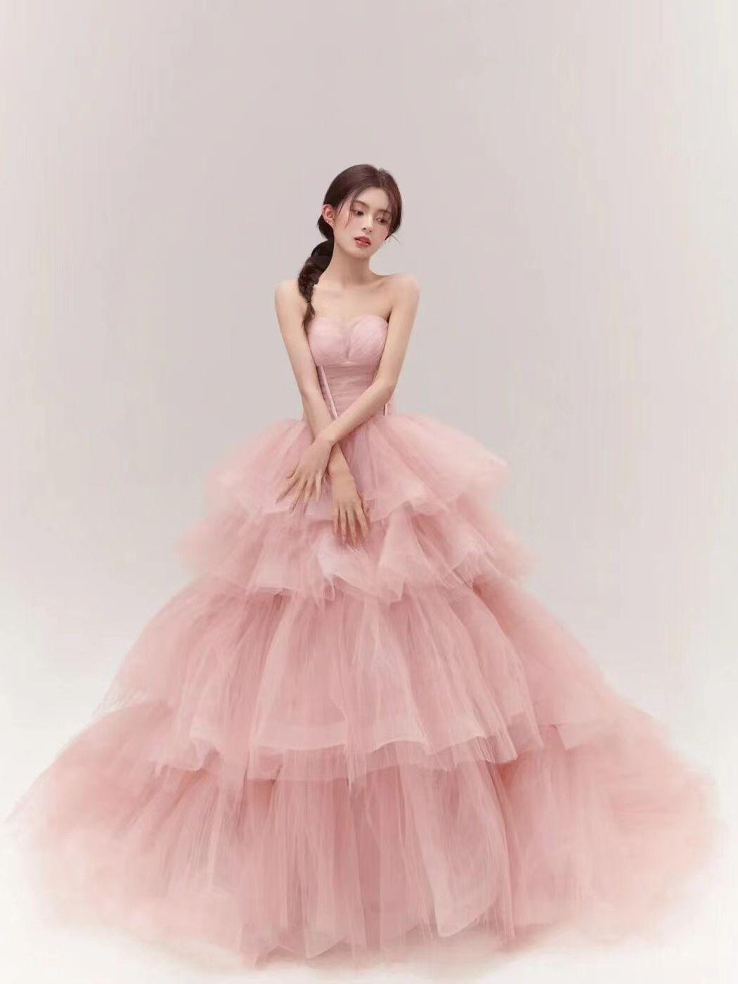 a soft pink dress fairy temperament multi-tiered tulle ball gown with a strapless bodice and flowing layers made from fairy temperament main yarn