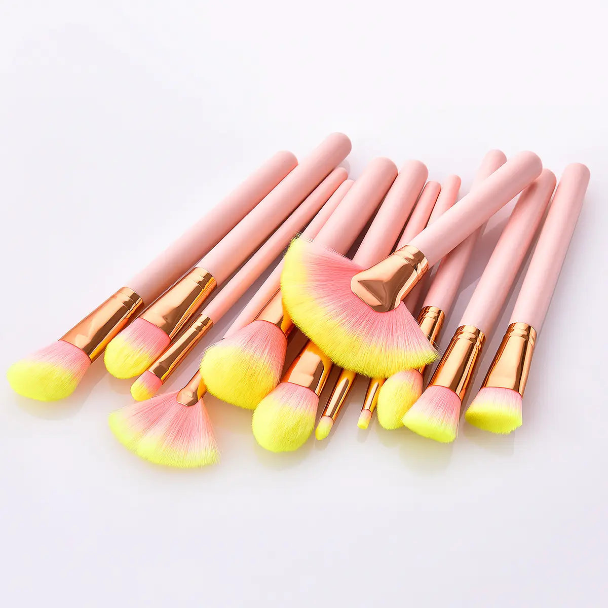 Set of 12pcs beauty makeup brushes featuring pastel pink and neon yellow gradient bristles with rose gold ferrules for precise cosmetic application.