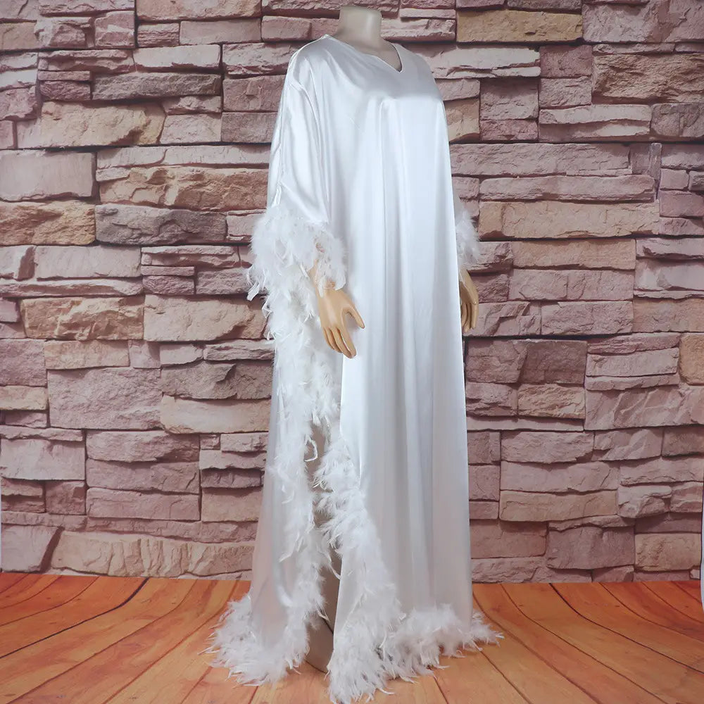 white satin maxi loose dress luxury with orange feather trim along sleeves and hem fully surrounded for an elegant robe look