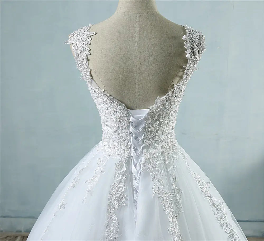 white lace v neck high waist wedding dress featuring delicate floral embroidery and back corset lacing detail showcasing the back side of the waist wedding dress