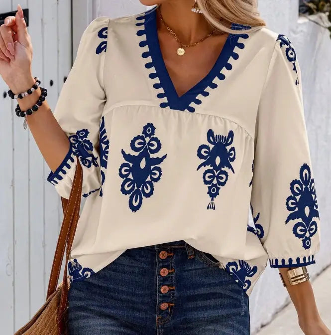 Cream-colored casual vacation shirt featuring navy blue embroidered floral patterns and decorative trim along the v-neckline, sleeves, and hem, ideal for holidaya random print style.