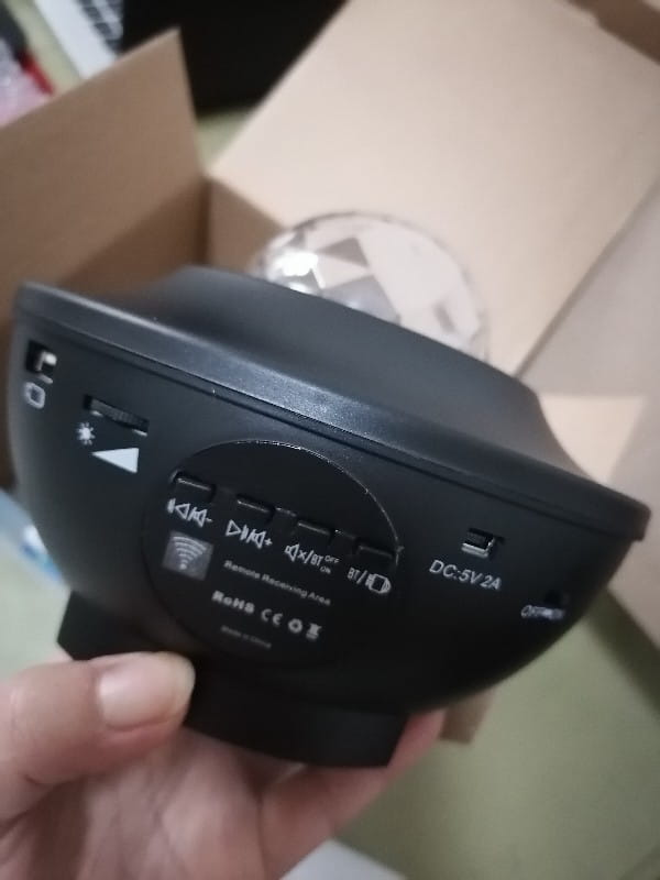 black plastic usb control music starry projection night light with multiple input ports and dc 5v2a power specification shown from the back side with remote control functionality