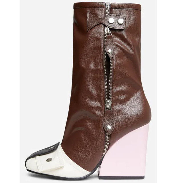 Brown leather high heel short tube boots with a contrasting white and black toe cap, silver side zipper, and bold pink wedge heel.