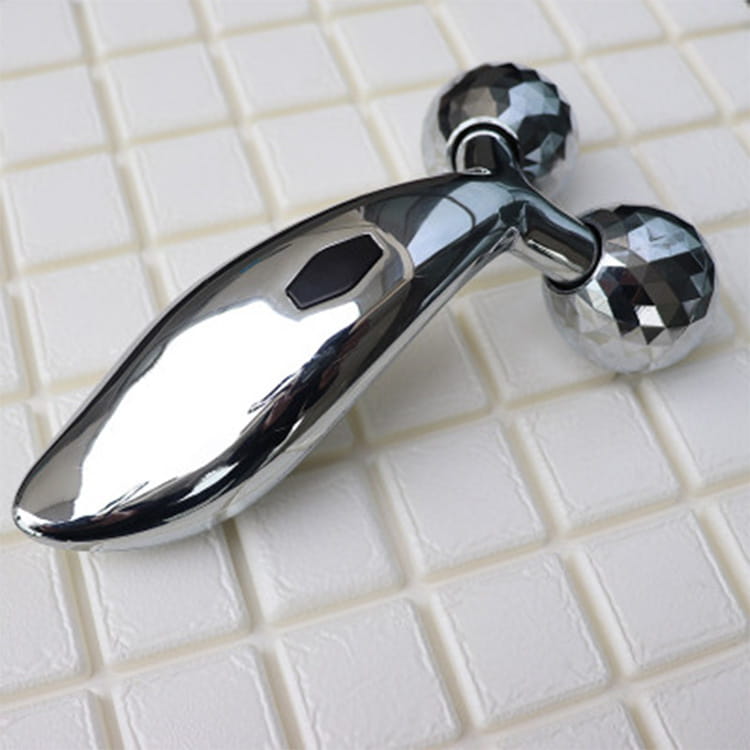 silver facial roller massage device with shiny chrome finish and two faceted diamond-like spherical ends shown in massage device image