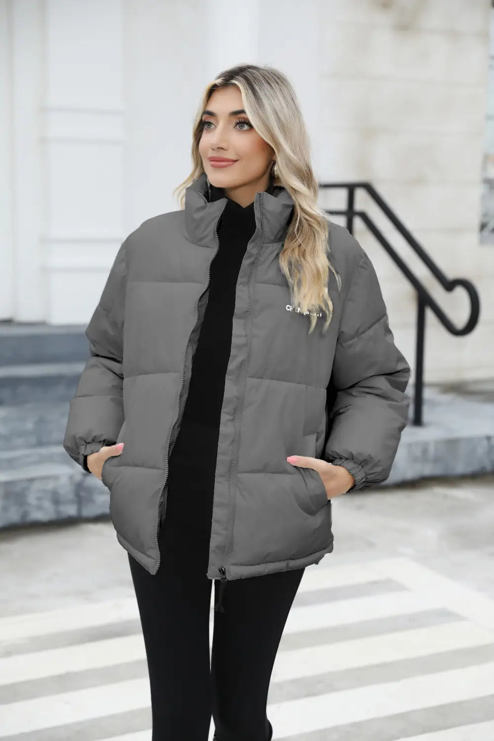 Gray puffer jacket with a high collar and subtle brand logo on the left chest designed as a women casual windproof winter coat women for everyday use.