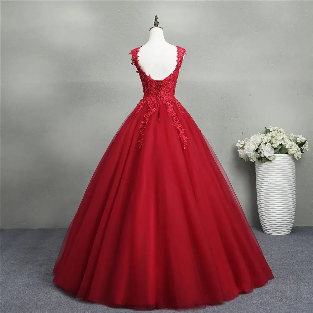 A vibrant red lace bride princess dream ball gown crafted from layered tulle with intricate lace detailing along the back and bodice for a flowing silhouette.