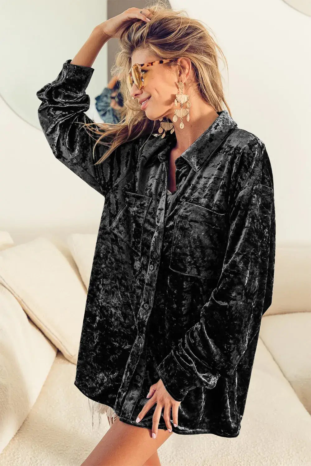 Oversized black long sleeve velvet shirt with a relaxed fit and frayed hem made from soft sleeve velvet fabric.