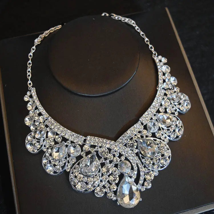 A sparkling silver choker necklace adorned with cascading teardrop and round crystals from the crystal bridal headdress flowers jewelry set suitable for flowers wedding hair and headdress flowers wedding looks.