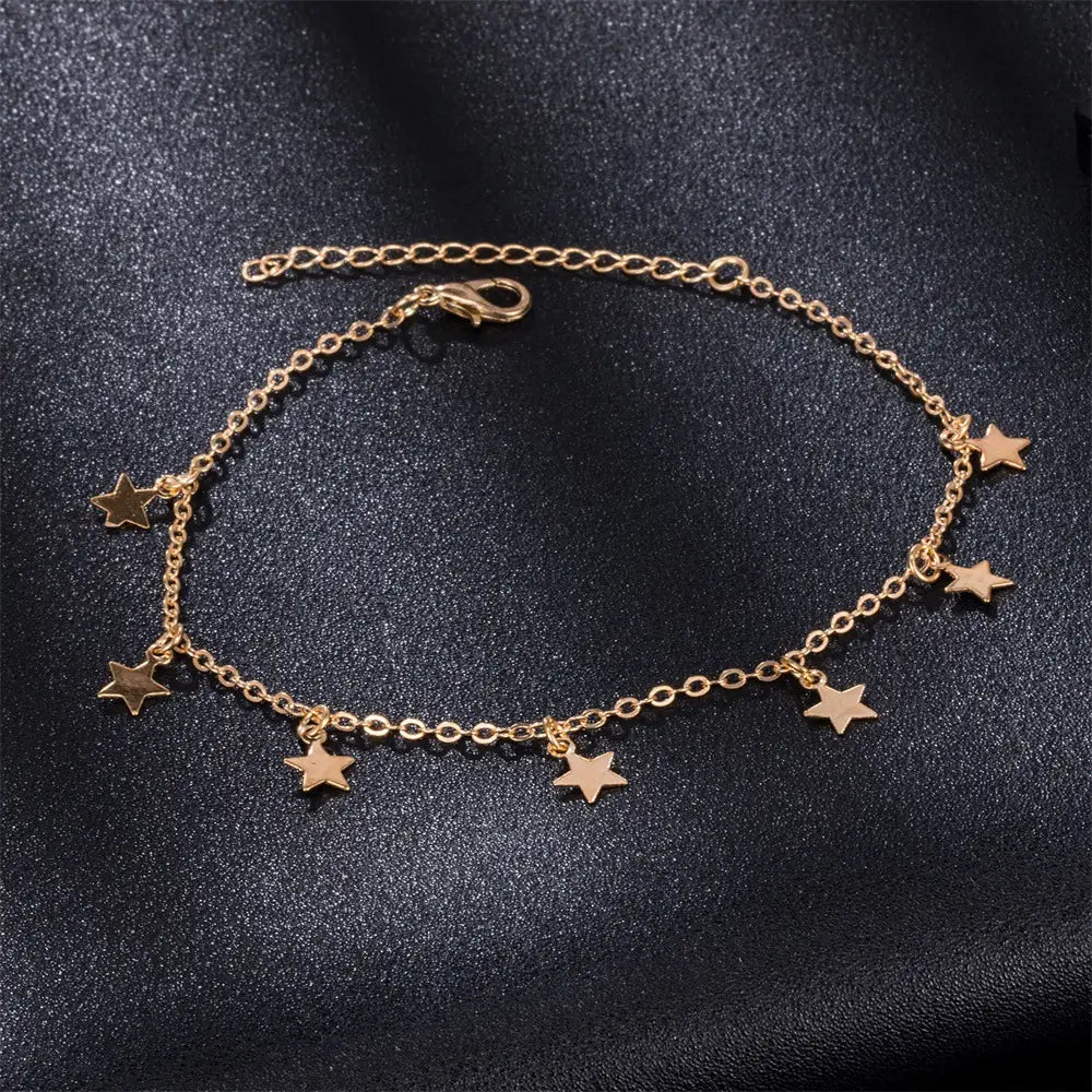 Gold-toned star charm anklet with a delicate chain and five dangling stars featured in silver star fashion anklet jewelry as simple star fashion and fashion anklet jewelry.