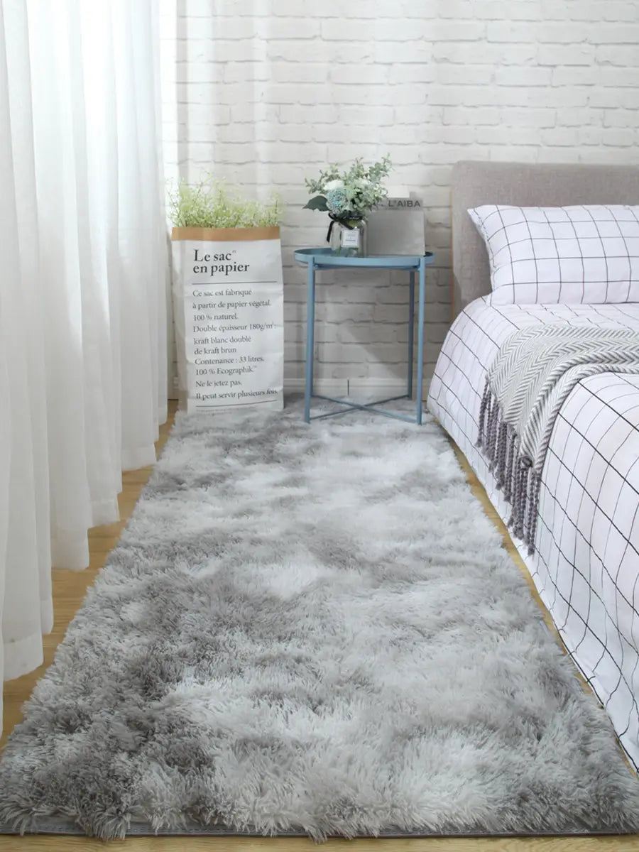 a plush gray shaggy carpet floor mat with a soft fluffy texture and subtle gradient shading for comfortable indoor use