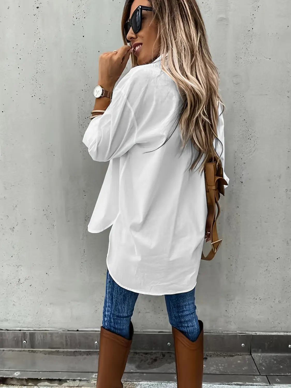 white oversized button-up shirt featuring long sleeve lapel design and relaxed fit ideal for casual or professional wear