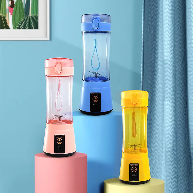 three portable electric fruit juicers in pink blue and yellow with clear bodies colored lids and bases and a power button on the base for usb rechargeable mixing