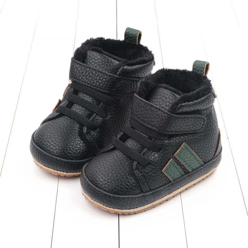 Plush lined sports soft-sole cotton baby shoes in black textured leather with green accents and a soft lining for comfort.