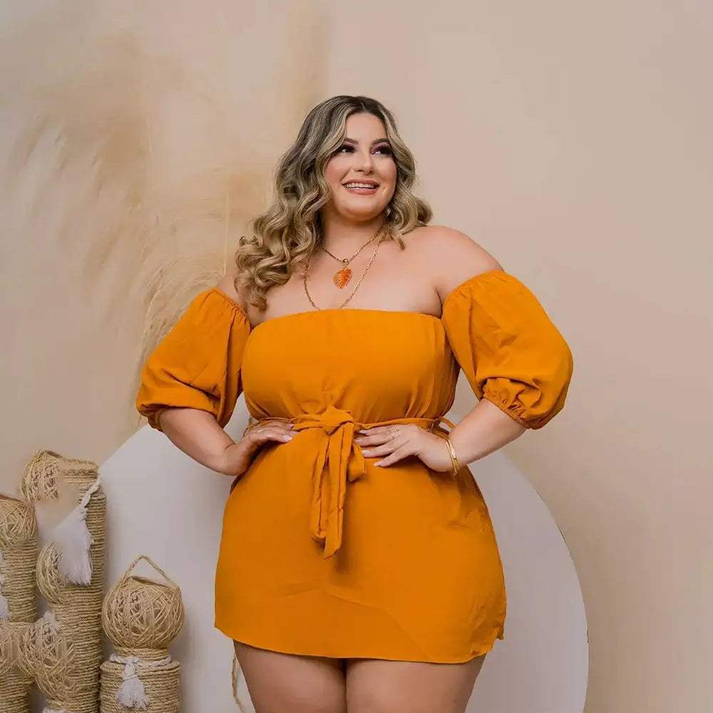 A vibrant orange off-the-shoulder mini dress with puffed sleeves and a tied waistband designed for plus size ladies featuring comfort stretch shorts.