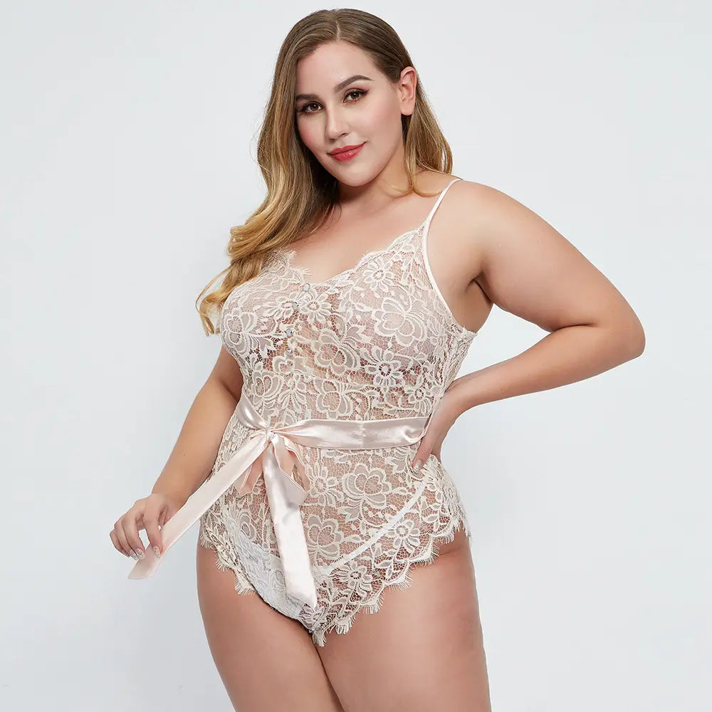 a delicate off-white oversized lace lace bodysuit made of intricate lace with a satin ribbon belt