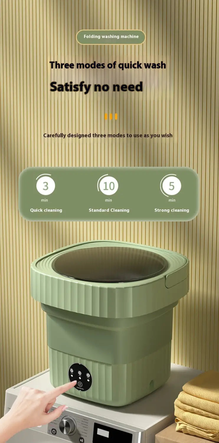A compact mint green folding washing machine with a ribbed exterior and a circular control panel designed for efficient folding washing.