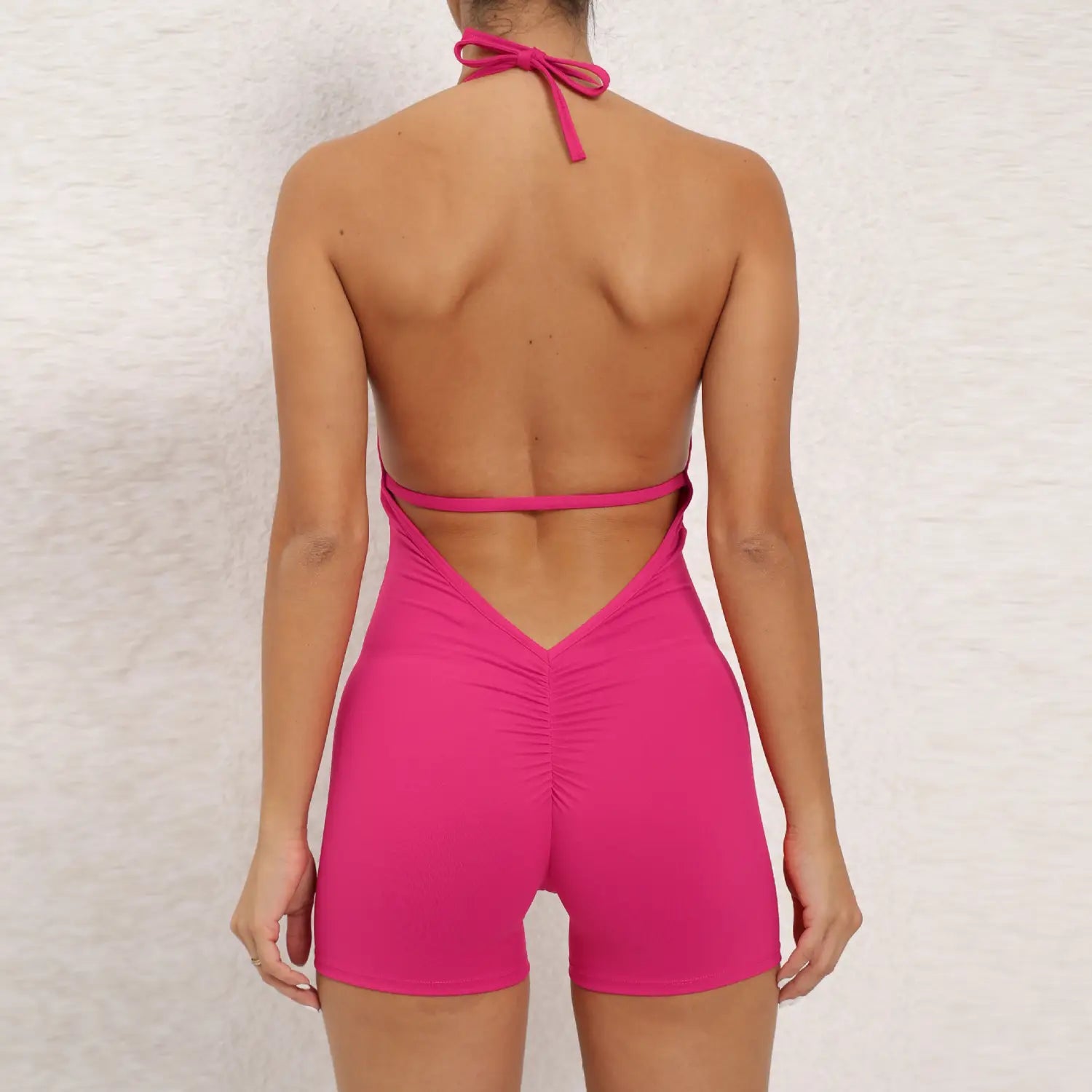 a vibrant fuchsia halter neck high elastic one-piece swimsuit with a back tie and cutout design, suitable as yoga pants halter style.