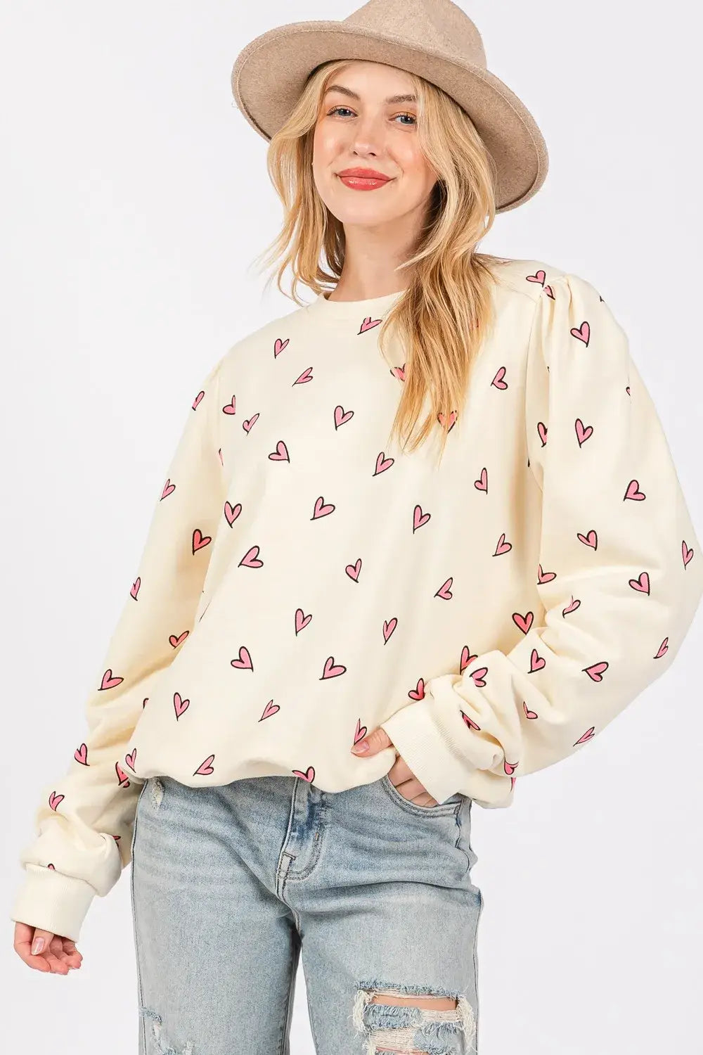 Cream-colored sage fig heart printed long sleeve sweatshirt with a soft cozy texture and all-over pink heart print.