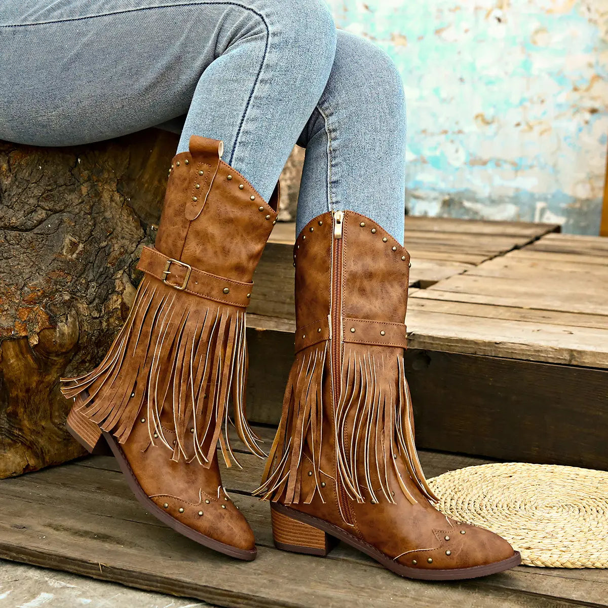 Brown suede cowboy boots with fringe metal studs and a fashion square heel perfect for retro winter fashion.