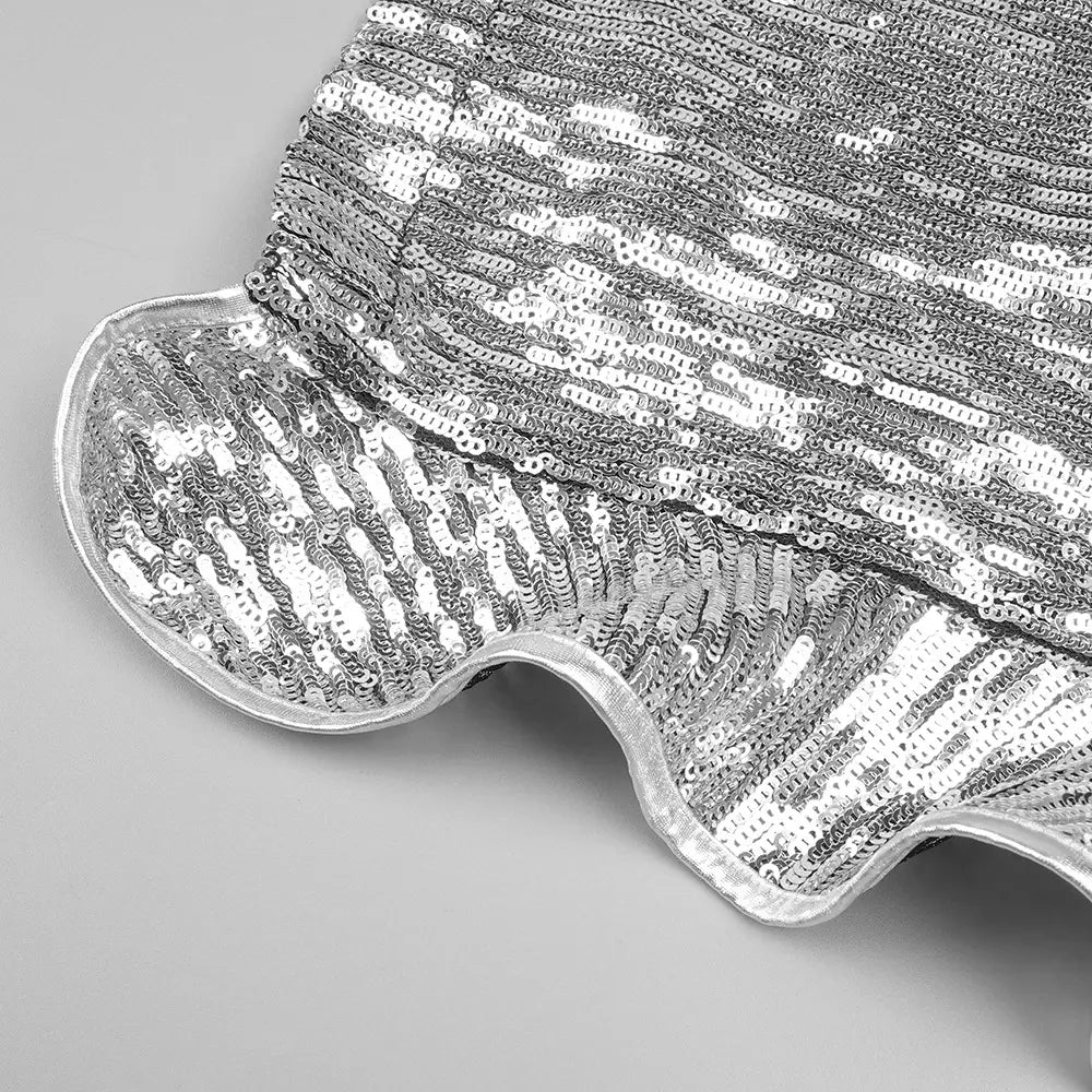 a shimmering silver sequined hat with a ruffled brim complements the silver strapless sequin skirt set.