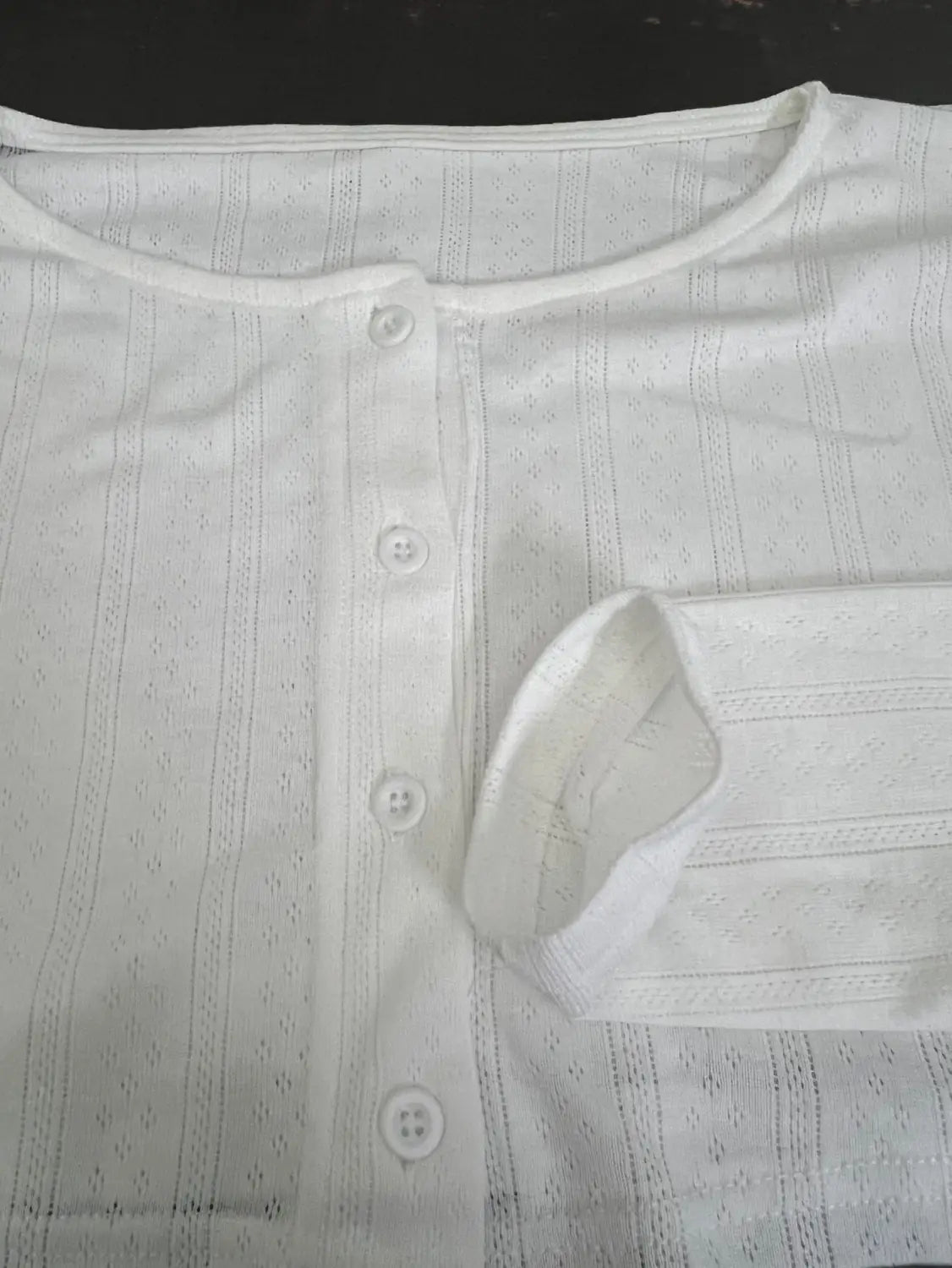 white embroidered button-up shirt with subtle striped pattern and delicate lace detailing paired with a white ribbed knit fashion cardigan long sleeve
