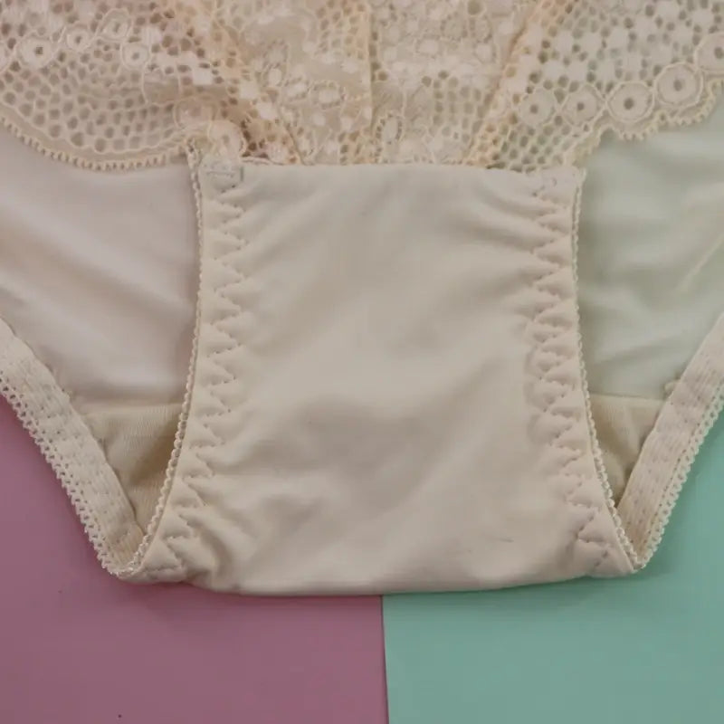 Cream-colored plus size underwire lingerie set featuring lace trim with scalloped edges and smooth satin-like fabric.