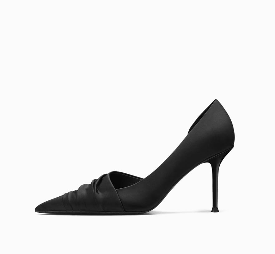 black cloth satin ruched high heels with a pointed toe and sleek minimalist design shown from the back
