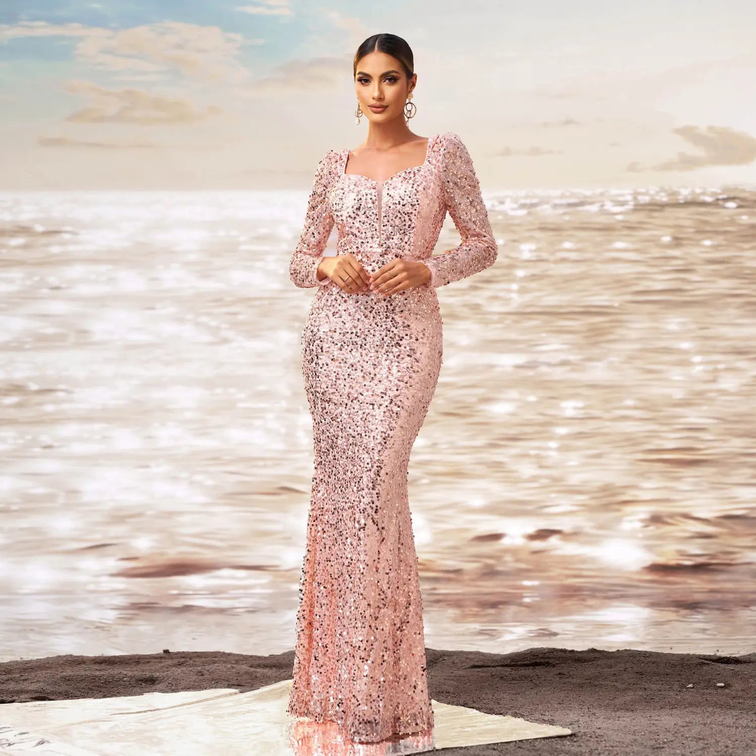 a shimmering pink sequined sheath fishtail evening dress with long sleeves and a square neckline