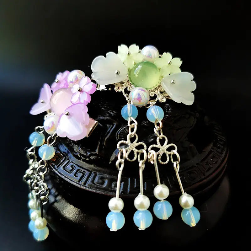 Pink floral retro headgear girls hairpin featuring an ornate silver filigree clip adorned with translucent white and pink floral beads, a central green opal stone, and dangling blue opalescent beads and pearls.