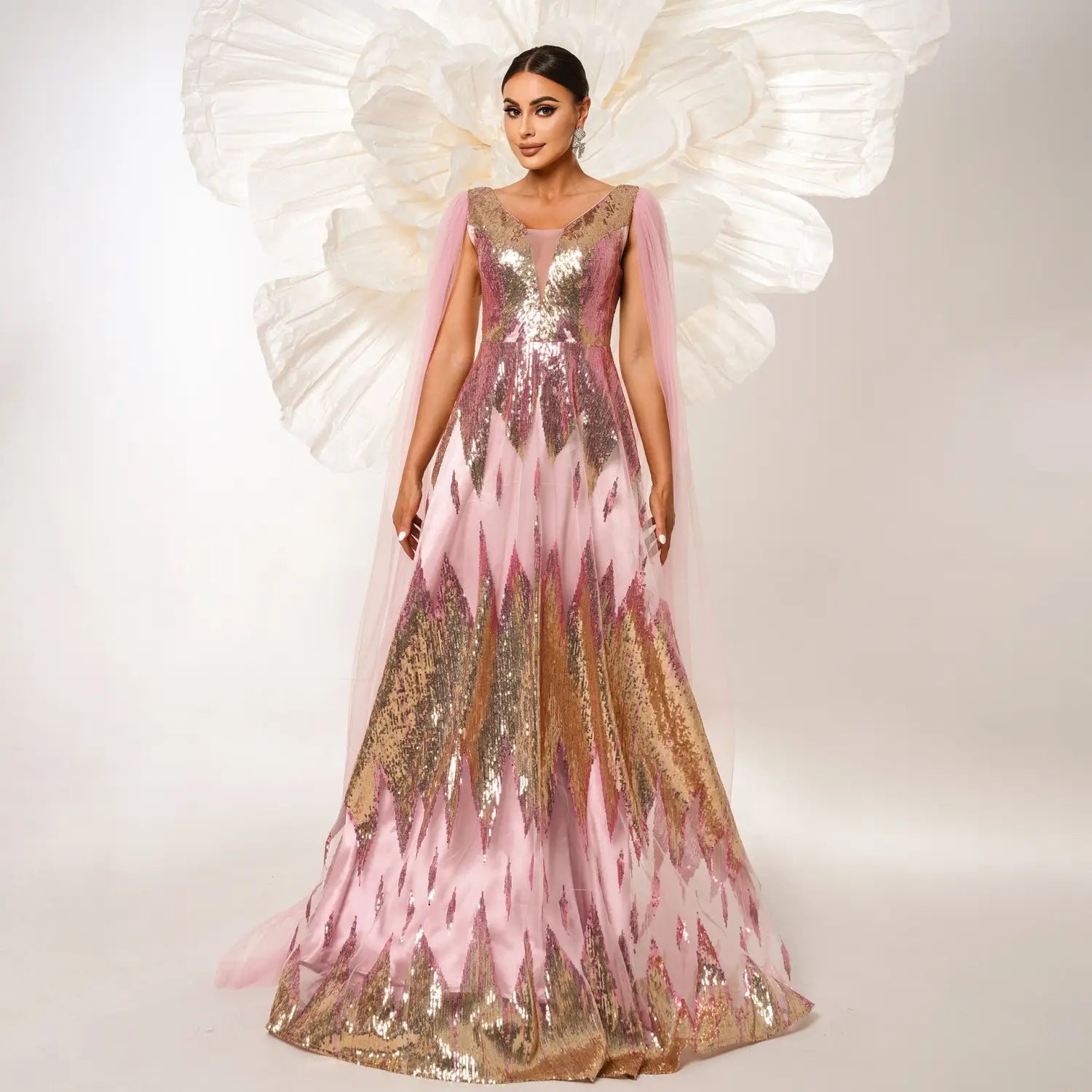 A shimmering pink and gold mesh long sleeve sequins large swing dress with a sheer capelet detail.