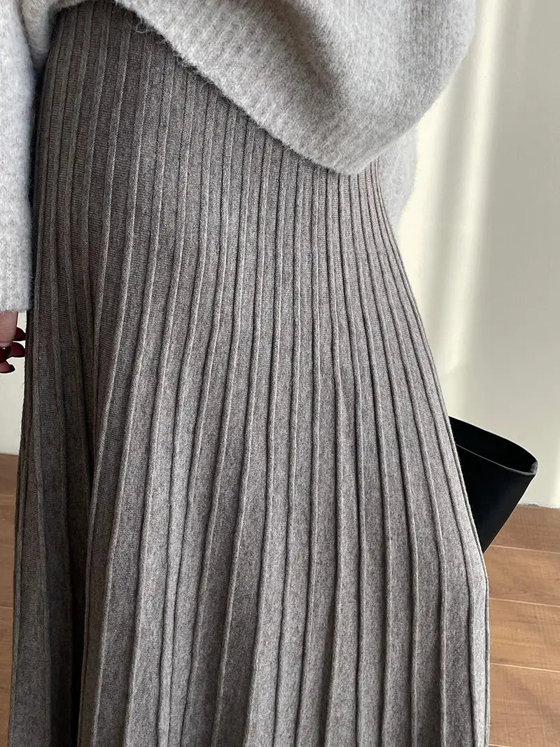 a soft heather gray ribbed knit pleated midi skirt featuring a korean elastic waist knitted design for comfortable wear