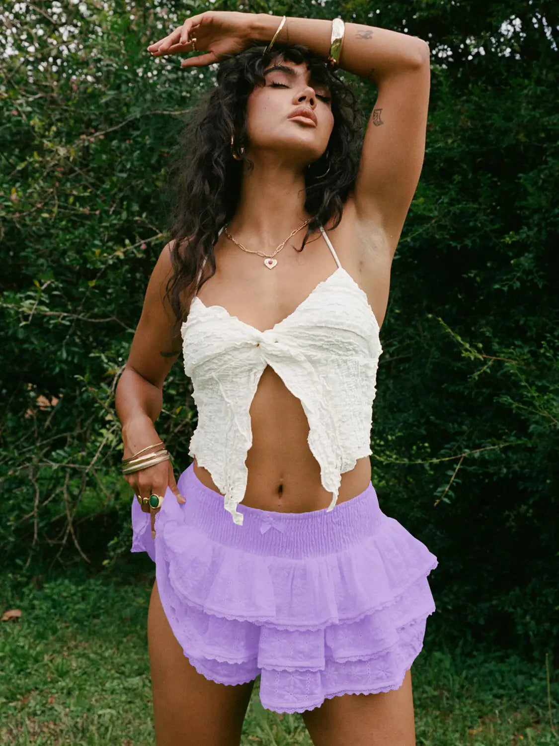 white textured lace crop top featuring a bow decorative front detail paired with a white eyelet lace bud skirt