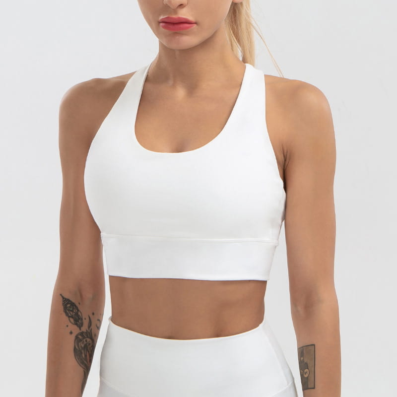 white racerback sports bra with seamless stretchy fabric and supportive band designed for women’s shockproof running and yoga activities