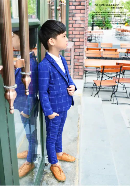 Blue plaid children’s three-piece fashion suit featuring a blue checkered comfort suit with matching trousers and a white shirt underneath.