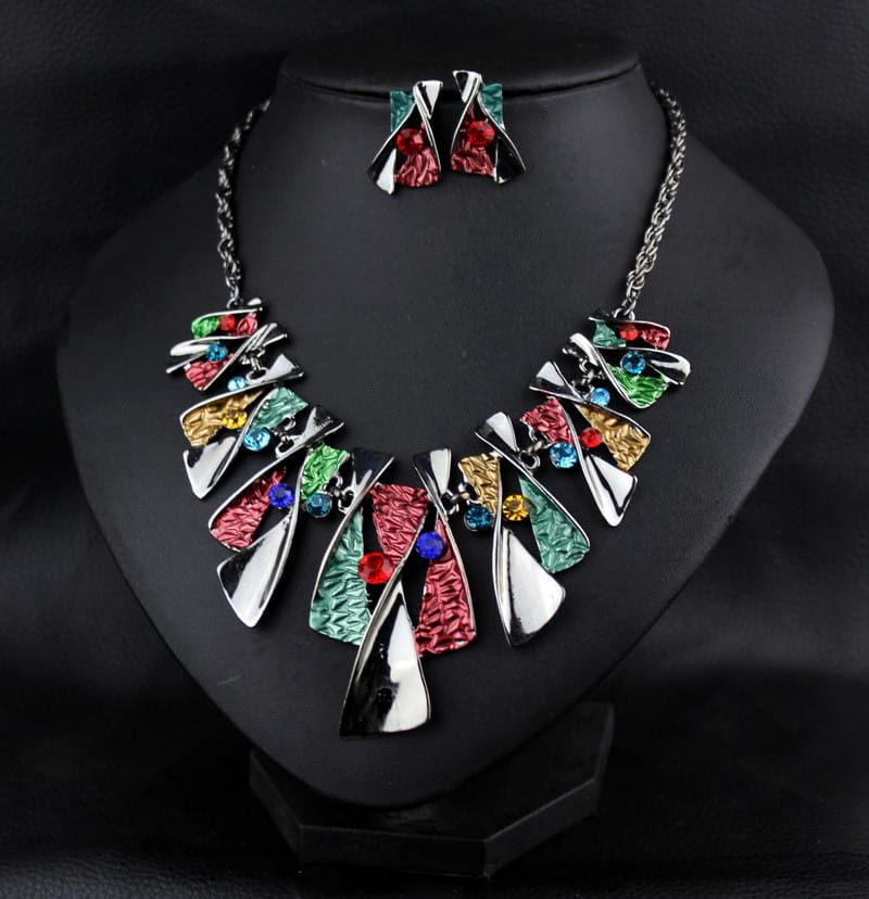 Metal geometric shape rhinestone earring necklace set featuring a vibrant statement necklace with metallic silver and multicolored enamel pieces accented by colorful rhinestones paired with matching shape rhinestone earrings.