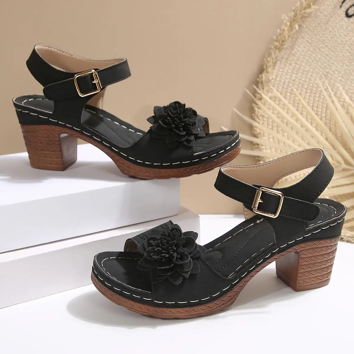 Black suede chunky heel sandals with floral embellishment and wooden block heels ideal for heel sandals summer.