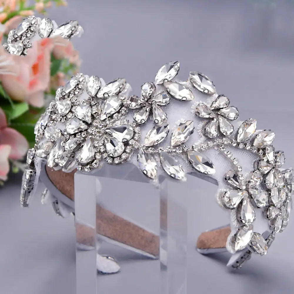 A sparkling silver rhinestone fashion retro headband featuring intricate floral and leaf designs on a delicate white fabric base.