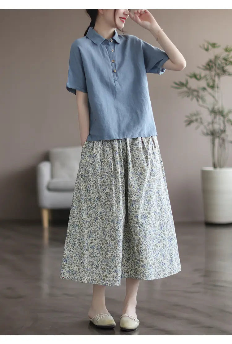 light blue short-sleeved polo shirt with button front and relaxed fit paired with an artistic floral washed cotton midi skirt