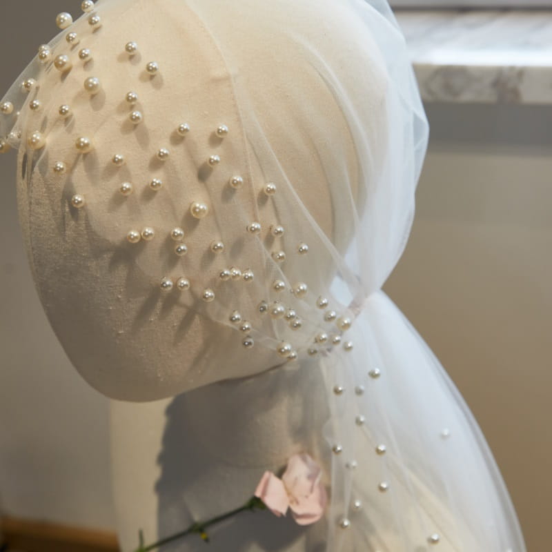 a delicate ivory tulle super fairy long pearl veil bridal hijab adorned with scattered pearl-like beads