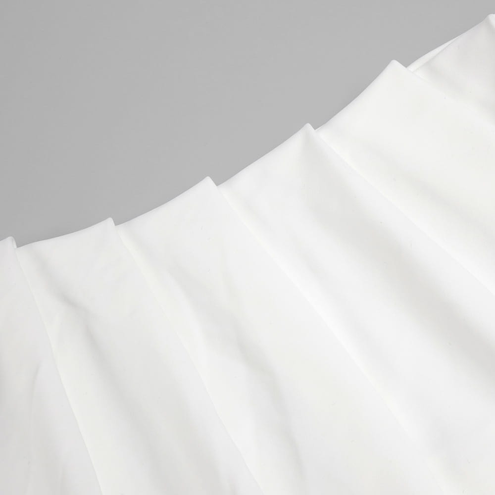 white softly pleated satin fabric showcasing the smooth texture of the ribbon flower halter style white ribbon gown